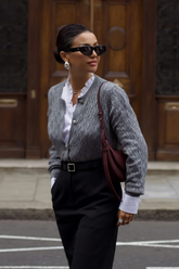 a lady wears a v-neck white blouse with a grey cardigan